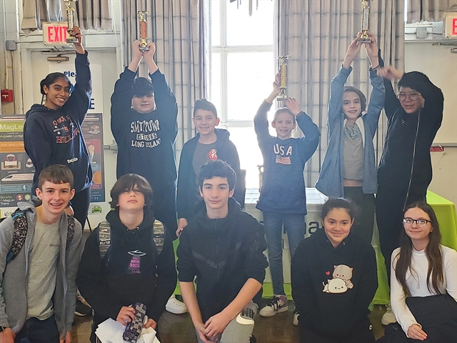 students posing with their trophies