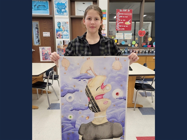 picture of student holding artwork