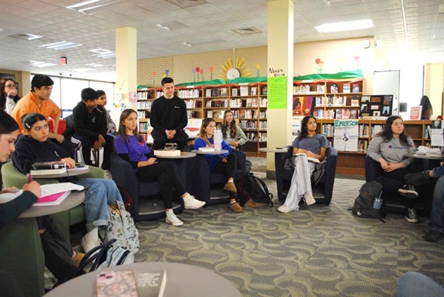 Students in a group reciting poetry