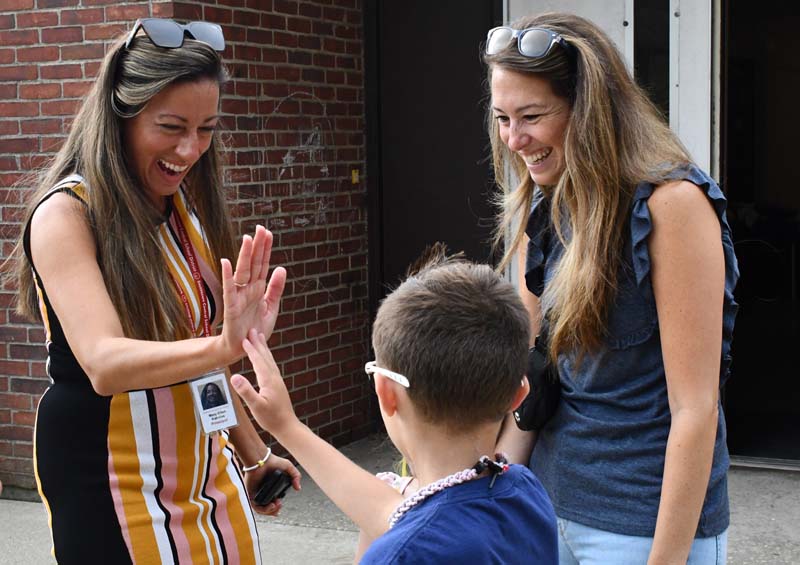 Principal giving high fives