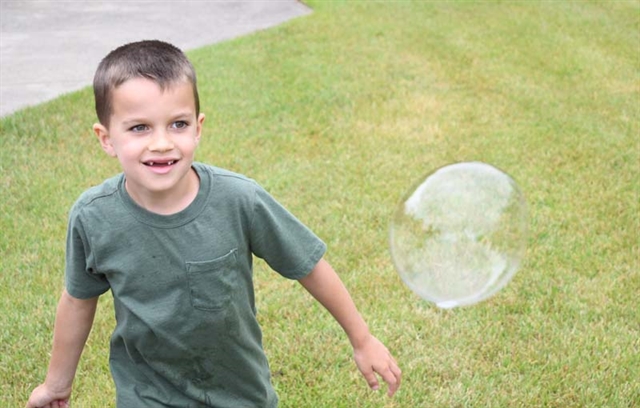 student playing with bubble