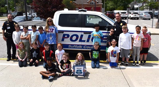 students in front of police truck