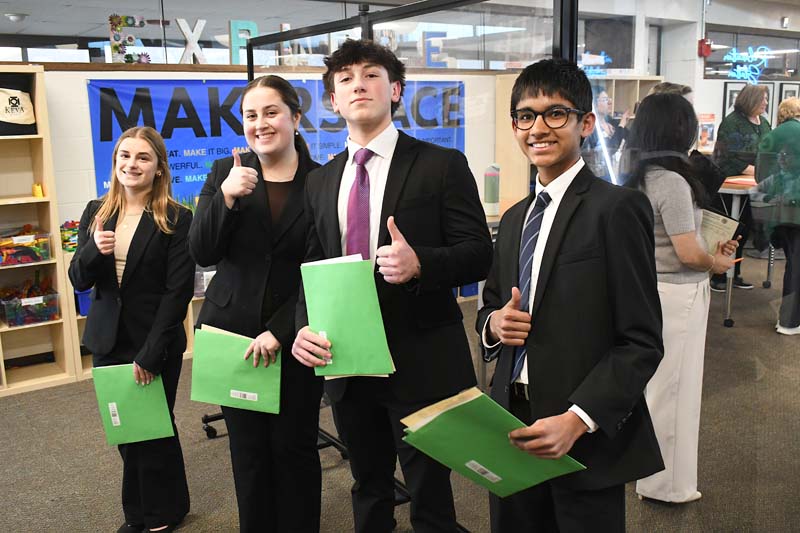 students giving thumbs up