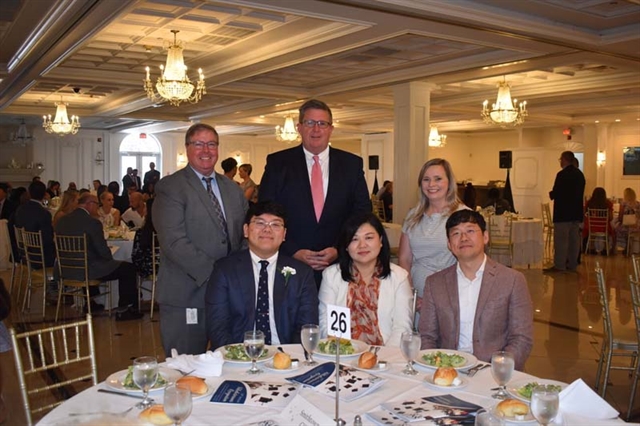 High School honor speaker and officials posing for picture