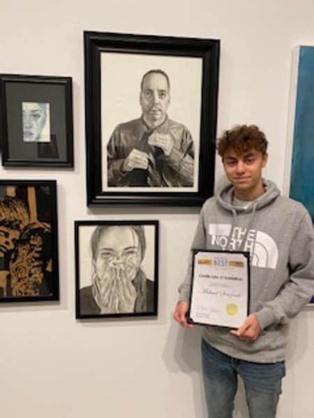 Student with his artwork