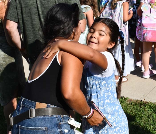 mom and daughter hugging