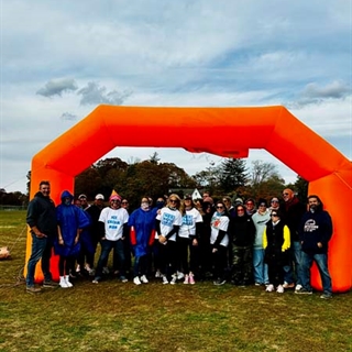 Students with color paint on them posing for picture