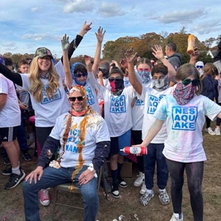 Students with color paint on them posing for picture
