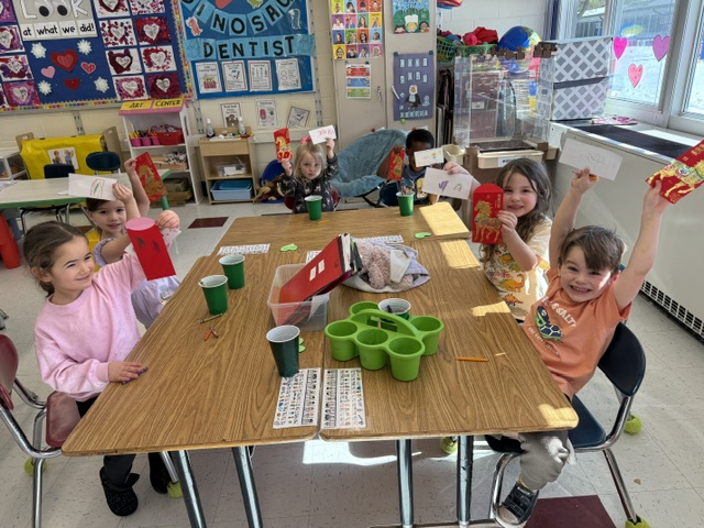 students smiling at table