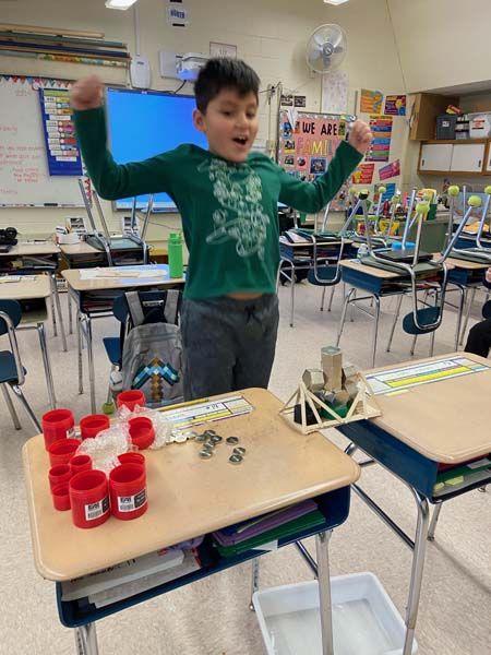 Student with popsicle bridge