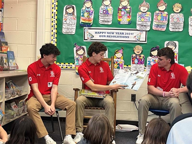 High School students reading to students