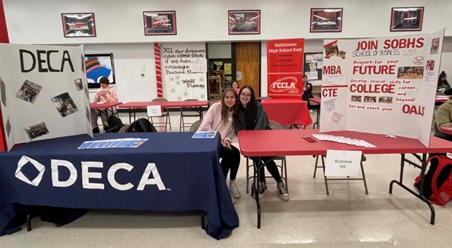 students at club fair posing for picture