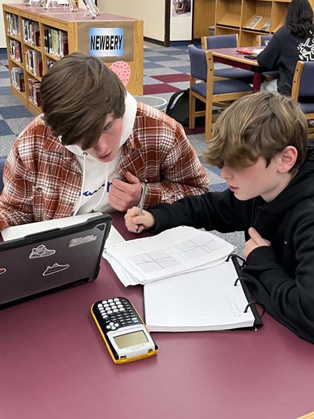 HSE student studying with younger student