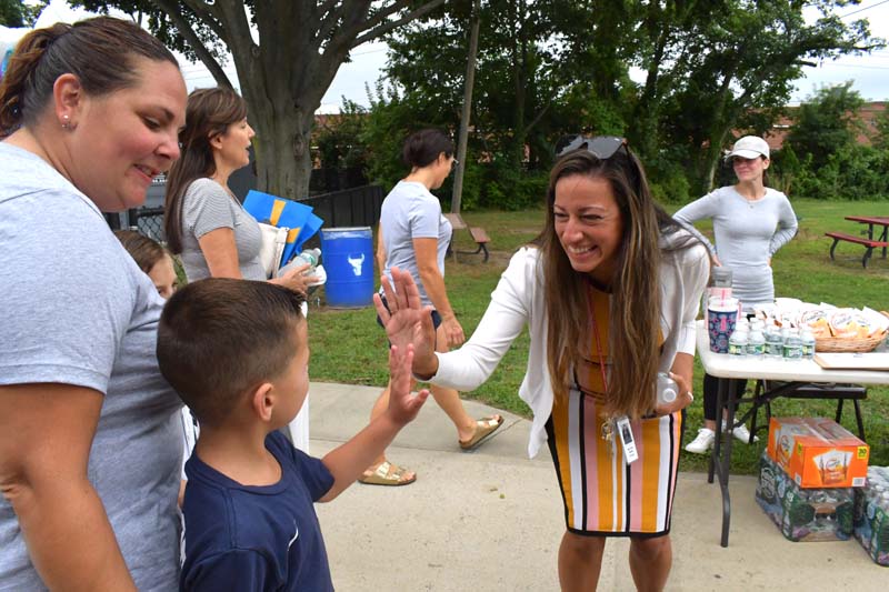 Principal giving high fives
