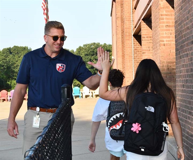 Principal McCabe greeting students