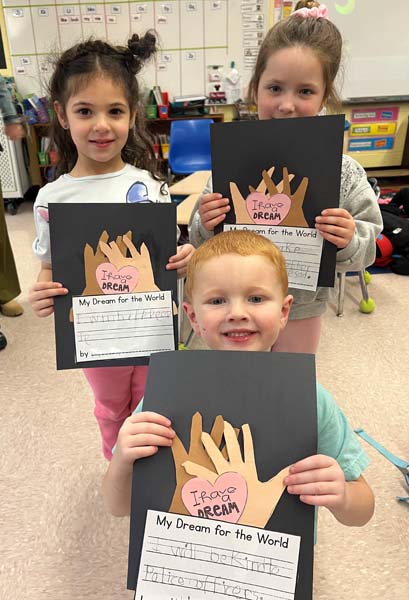 Mt. Pleasant students holding up artwork