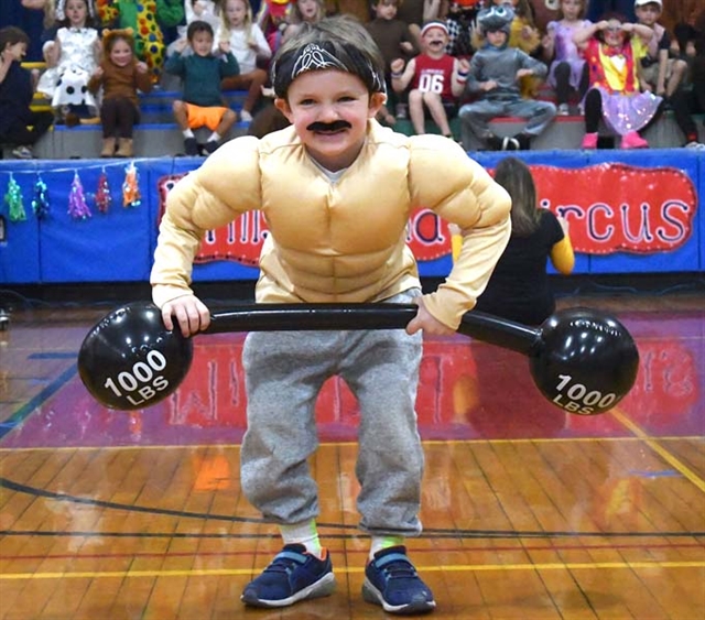 student dressed up and posing with muscles