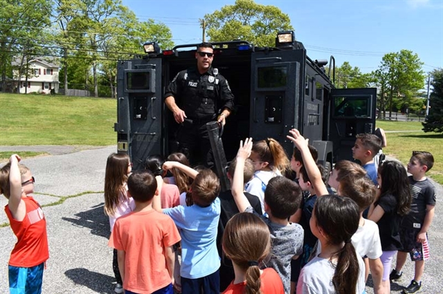 police officer talking to students