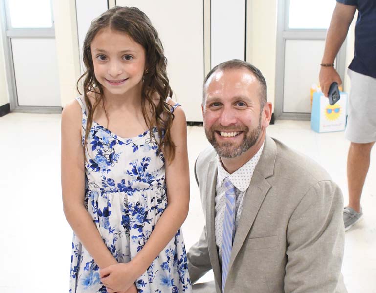 Principal with student smiling