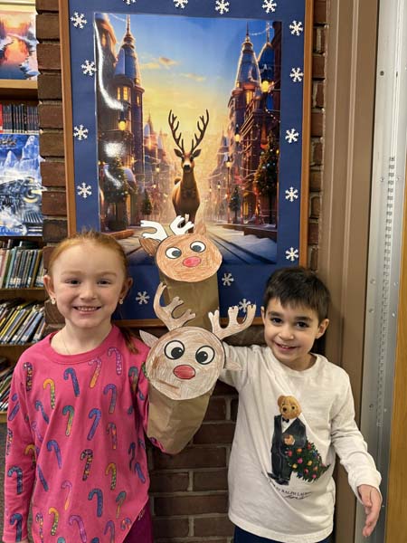 students holding reindeer art
