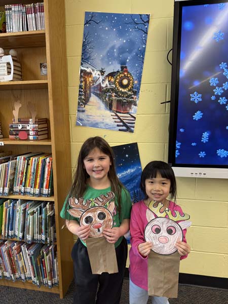 students holding reindeer art