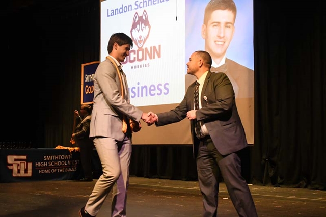 student on stage getting award