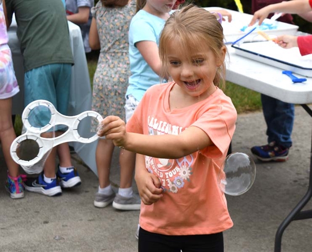 student playing with bubble