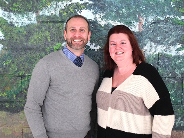 Principal and teacher posing for picture