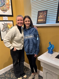 Student and adult with artwork