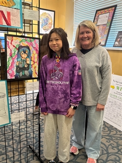 student and adult with artwork