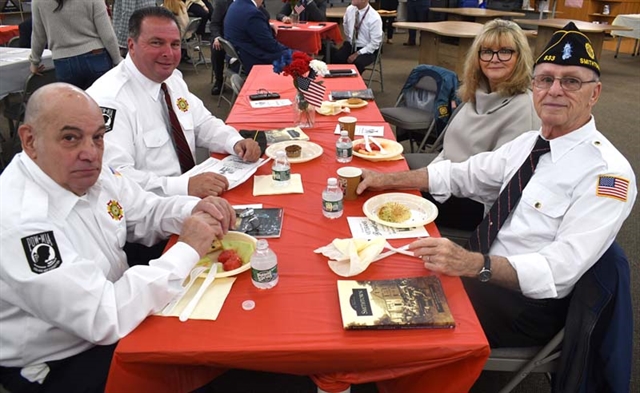 Veterans smiling at table