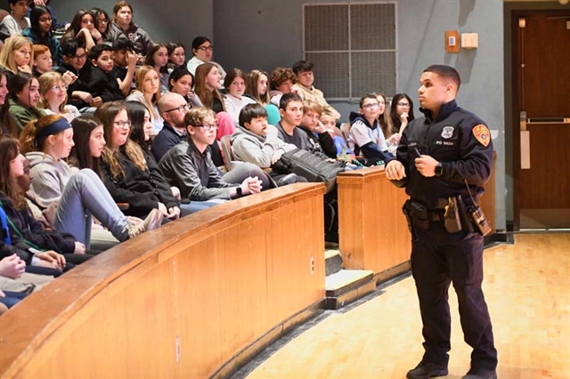 Officer Karl Allison speaking to students at Great Hollow Middle School