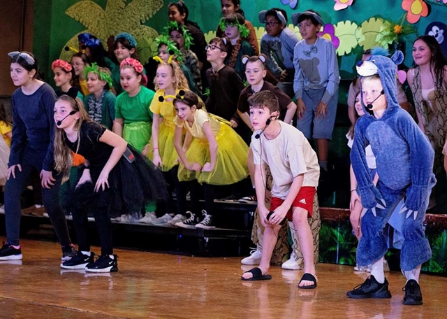 students on stage for performance