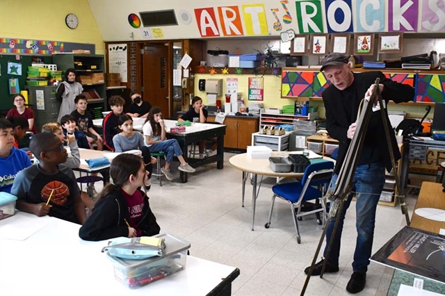 local artist talking with students