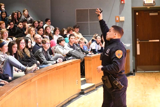 Officer Karl Allison speaking to students at Great Hollow Middle School