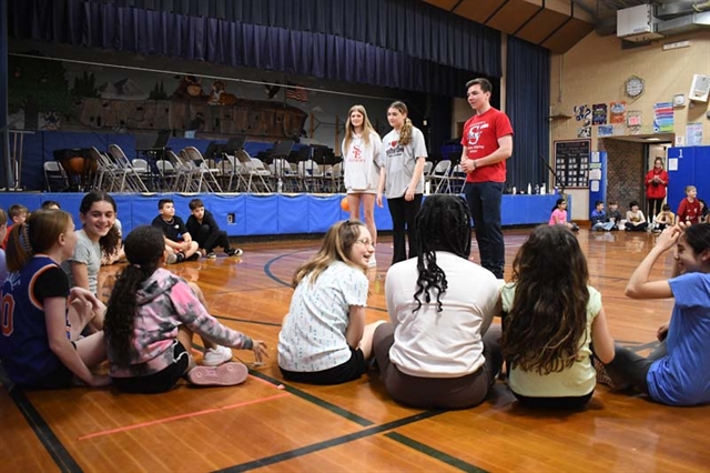 High School students speaking with younger students