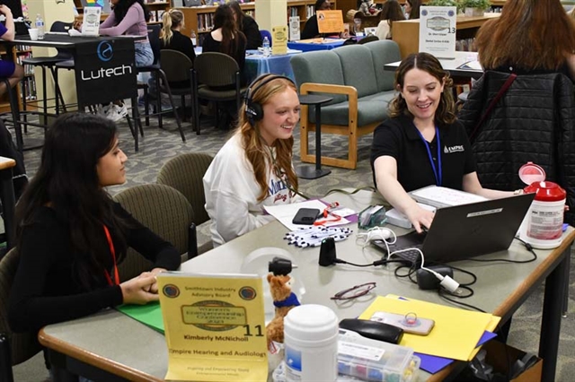 students at desk networking