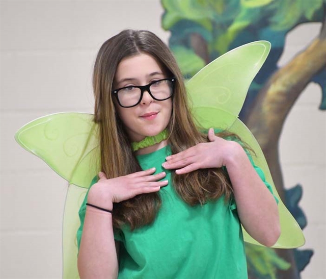 student on stage dressed as a bug