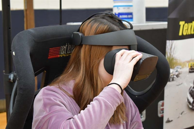 student in virtual reality driving simulator