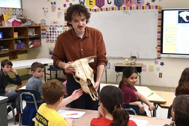 students touching animal bones