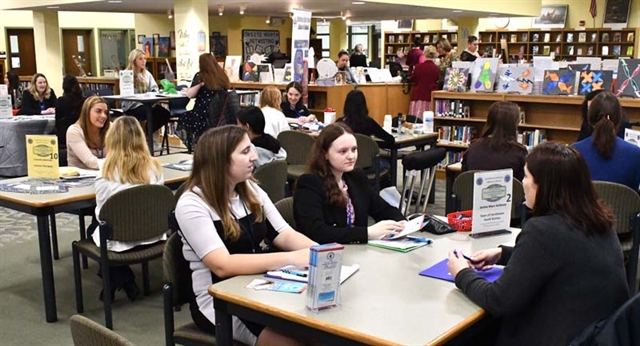 students at desk networking