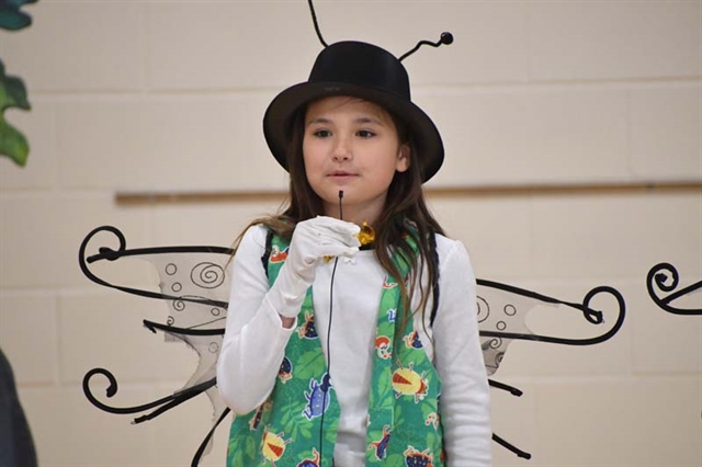student on stage dressed as a bug