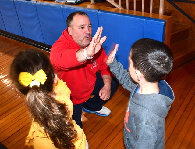 gym teacher giving a high five